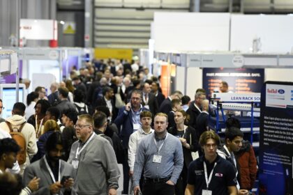 Engineers analysing factory data dashboards representing AI in manufacturing