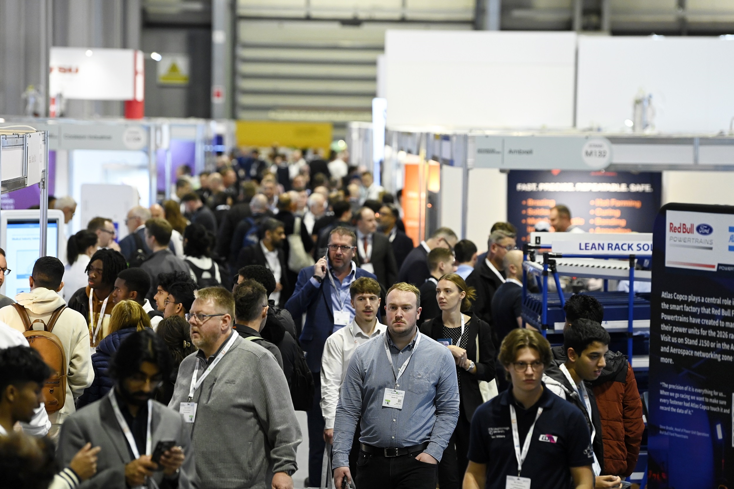 Engineers analysing factory data dashboards representing AI in manufacturing