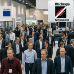 Visitors at Blechexpo and Schweisstec 2025 walking through a busy exhibition hall with the event logo visible on the right-hand side, showcasing industrial AI and automation displays.