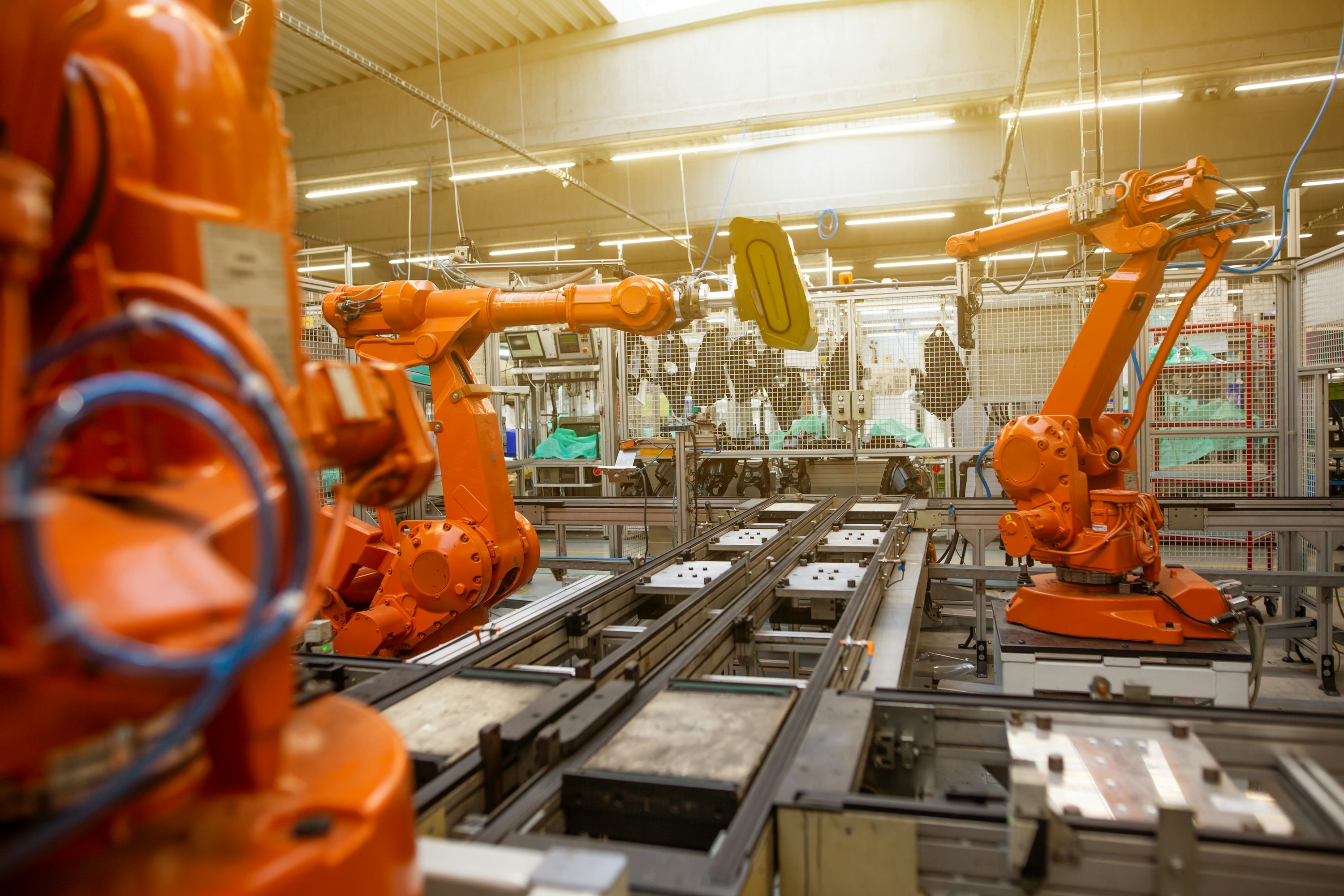 AI welding robots operating inside a modern German automotive welding cell using smart arc control