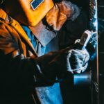 Real Time Weld Defect Detection sensor mounted on a welding torch in a bright industrial setting with clean metallic highlights