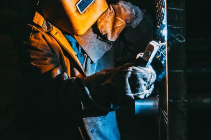 Real Time Weld Defect Detection sensor mounted on a welding torch in a bright industrial setting with clean metallic highlights