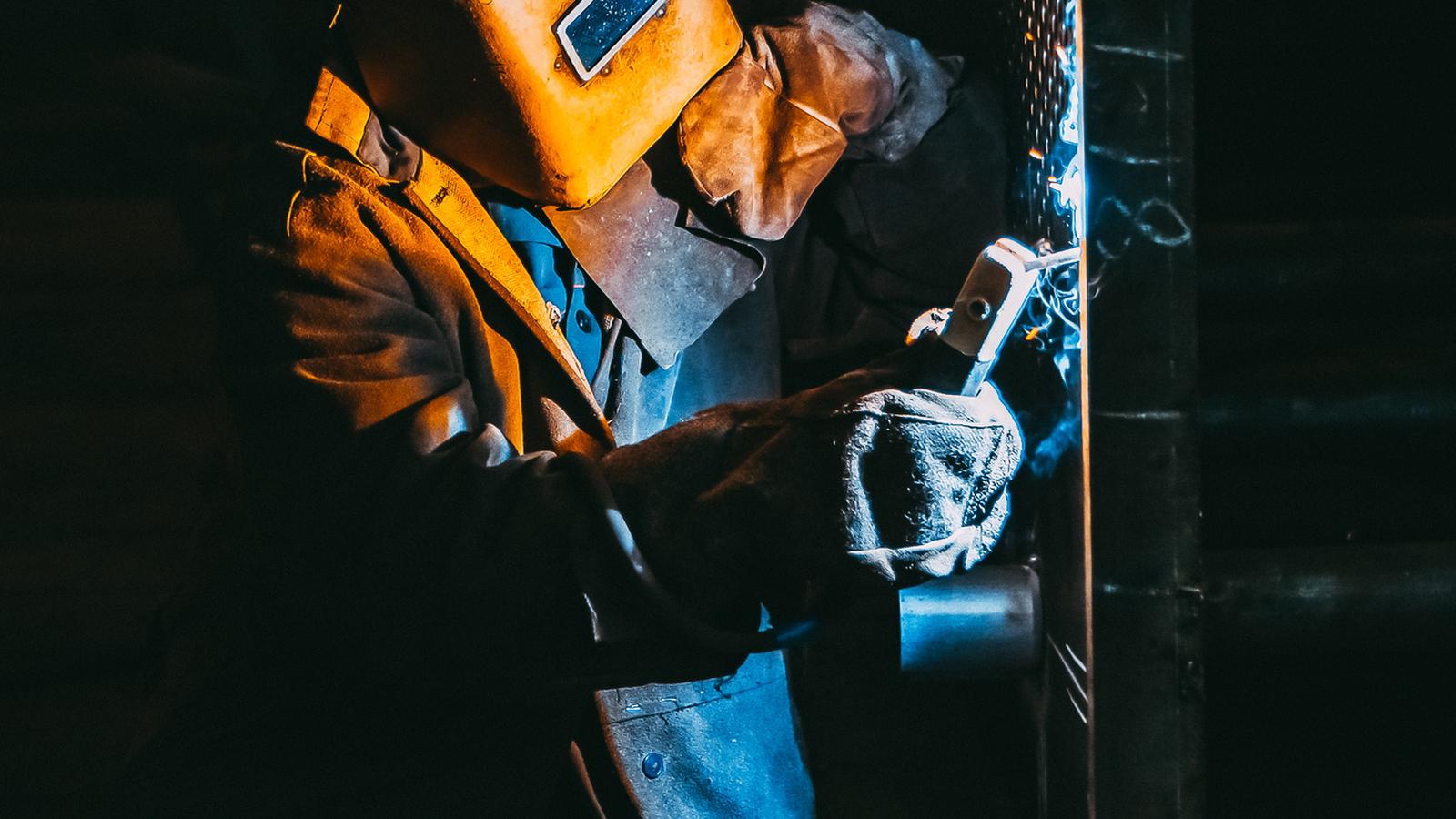 Real Time Weld Defect Detection sensor mounted on a welding torch in a bright industrial setting with clean metallic highlights