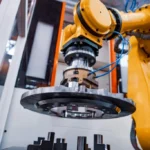 Industrial AI in CNC Machining 2026 robotic arm performing precision component handling in advanced automated manufacturing environment