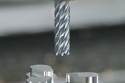 High-precision CNC end mill positioned above a machined aluminium component inside a modern industrial environment