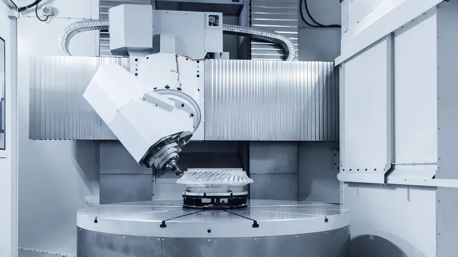 AI Toolpath Optimisation 2026 illustrated by a 5 axis CNC machining centre cutting a complex aluminium aerospace component