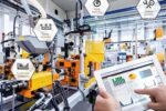 Industrial AI in factories analysing CNC machine production data in a smart manufacturing environment