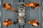 KUKA AMP Physical AI platform using industrial robots to weld an automotive body inside a North American car factory