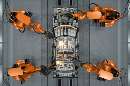 KUKA AMP Physical AI platform using industrial robots to weld an automotive body inside a North American car factory