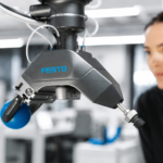 Festo GripperAI robotic gripper using AI vision to identify and handle mixed objects while an engineer monitors the system.