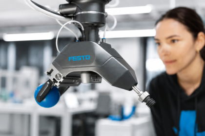 Festo GripperAI robotic gripper using AI vision to identify and handle mixed objects while an engineer monitors the system.