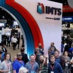 IMTS 2026 industrial AI exhibition at McCormick Place with manufacturing professionals, CNC machine tool stands and automation technology on the show floor