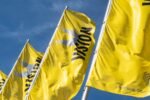 Yellow VISION flags flying outside Messe Stuttgart, host of the VISION 2026 machine vision exhibition.