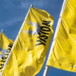 Yellow VISION flags flying outside Messe Stuttgart, host of the VISION 2026 machine vision exhibition.