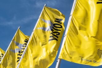 Yellow VISION flags flying outside Messe Stuttgart, host of the VISION 2026 machine vision exhibition.